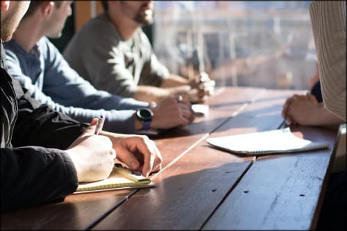 people wroking at an open table