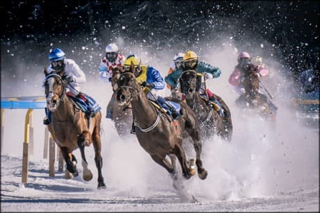 riders on horses, giving extra effort to succeed.