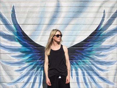 Angel Girl - woman standing in front of some wings