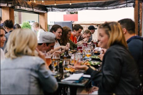 a collection of people eating together