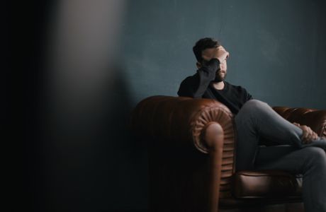 man sitting with his head in his hands