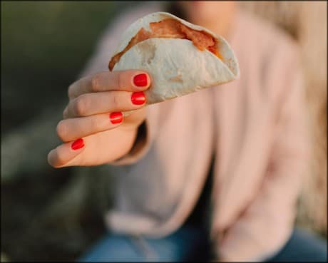 hand holding a taco