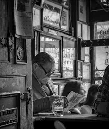 man sitting reading a paper