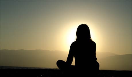 woman sitting in the sunset