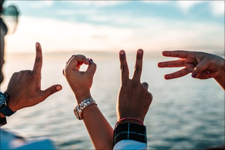 inspirational picture of 4 hands spelling out the word love.