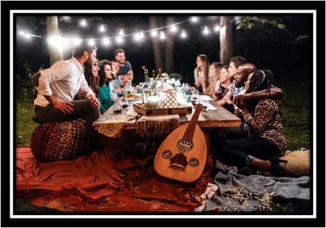 happy people around a table and music