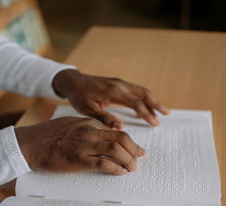 hands reading braille