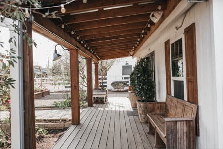 a farmhouse with a tree by the front door